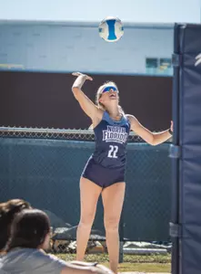 Blaire Register jumps to hit the ball.