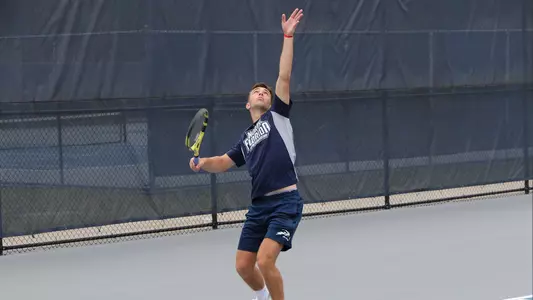 Matt Carroll goes for a serve