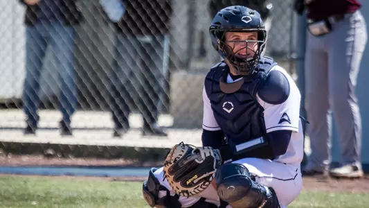 Austin Hurwitz prepares to catch the pitch from home plate