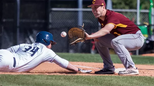 Chris Matthias slides in to the base with his arm outstretched before the baseman catches the pass