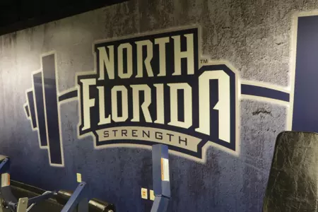 Wall with strength and conditioning logo blue and gray