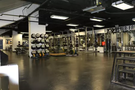 Long shot fo the weight room with weights in there