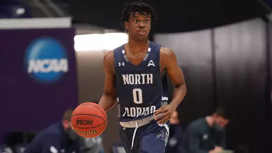 Emmanuel Adedoyin dribbles the basketball
