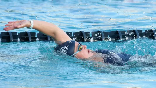 Annie Fletcher swims the backstroke in the pool.