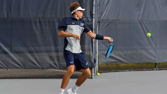 Patrick Kotan action shot hitting tennis ball forehand
