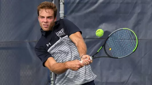 Nilo Duarte strikes a two-hand backhand