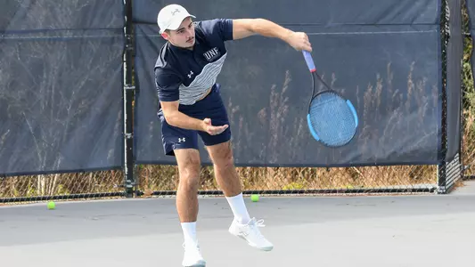 Joe Ellis follows through on a serve.