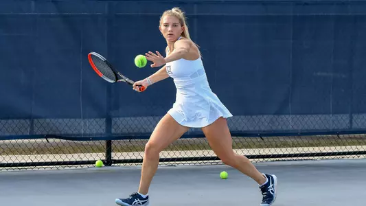 Annabelle Davis aims her racket at the ball.