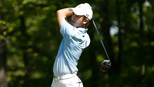 Robbie Higgins swings a golf club