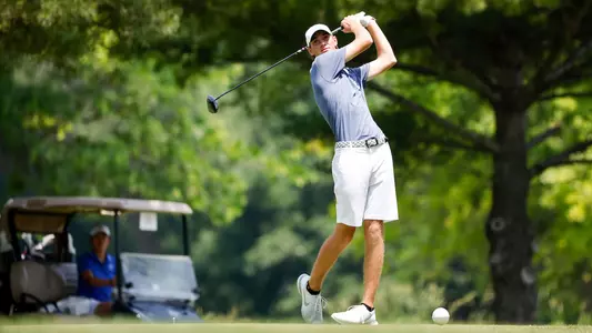 Nick Gabrelcik watches ball flight after taking a swing