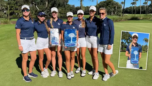 North Florida women's golf team poses with trophy beside the green after winning the 2021 Palmetto Intercollegiate