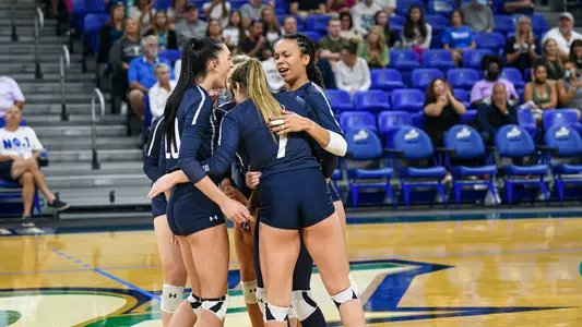 north florida volleyball team celebrating at FGCU.