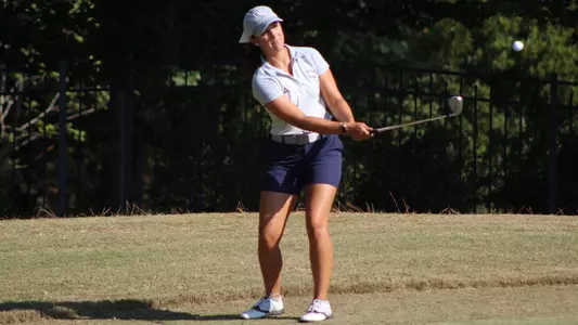 Mindy Herrick chips a ball from the fringe of the green