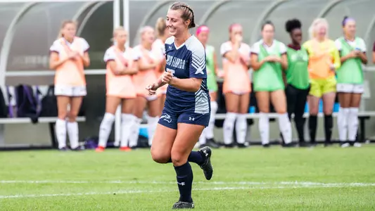 Marissa House celebrates with a fist pump after scoring a goal