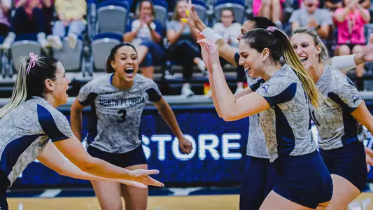 Julianna Askew and Solimar Cestero celebrating with a high five