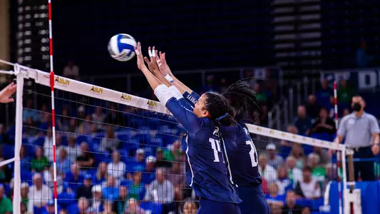 Maddie Boyd and Dariana Hollingsworth-Santana go up for a block
