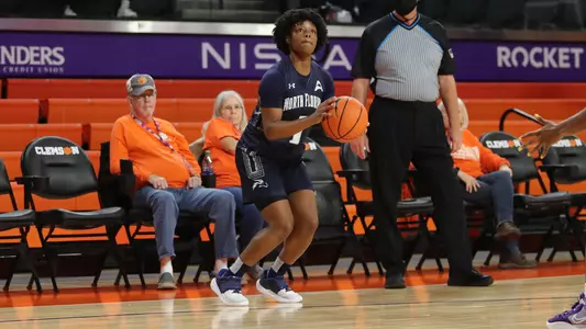 Nubia Benedith sizes up a shot.