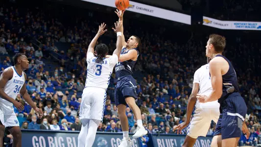 Jose Placer shoots a shot over the outstreched hand of a defender