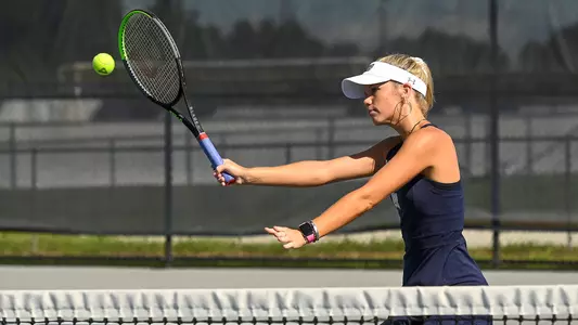 Kendall Nash swings her racquet
