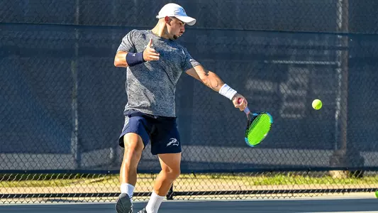 Joe Ellis makes a forehand attempt on a ball.