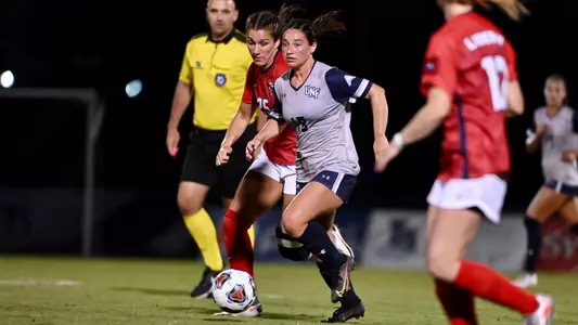 Mikayla Bond dribbling past the defense