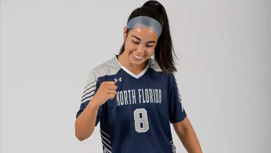 Ari Munoz poses doing a fist pump