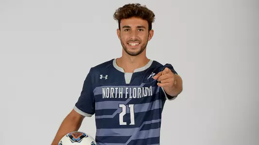 Ale Rodriguez Lopez points at the camera with a soccer ball.