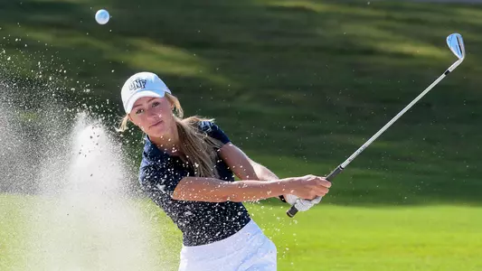 Sara McKevitt hits a ball out of a sandtrap