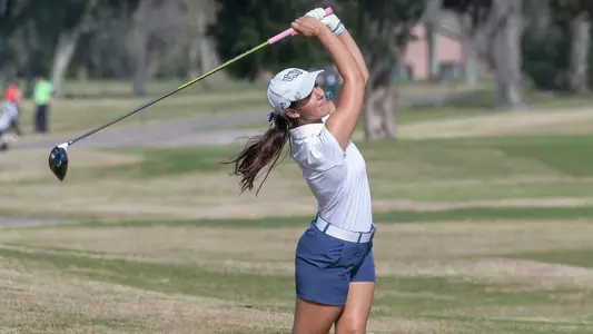 Mindy Herrick finishes her swing on the fairway