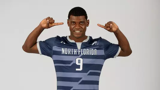 Jovoney Brown stands with his fingers pointing towards his head confidently