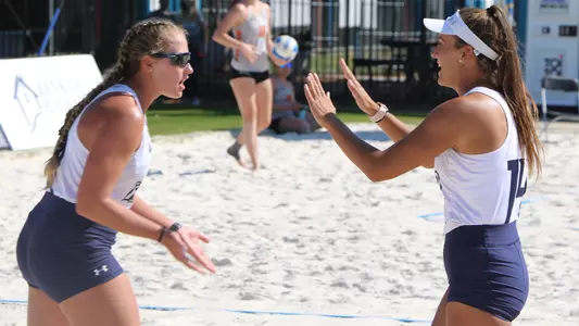 Carleigh Semeniuk and Lauren Galinis celebrate a point.