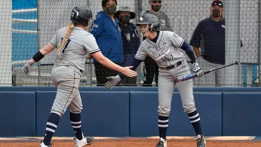 Rebecca Koskey & Britney Purser celebrate after a home run.