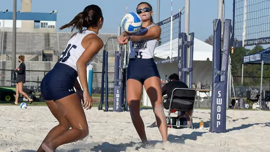 Chantel McMillan digs out a ball for Angelie Rosario.