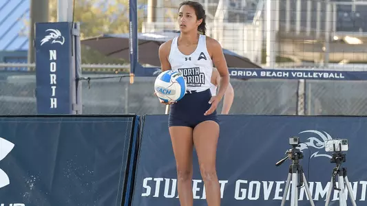 Angelie Rosario prepares to make a serve on the ball.