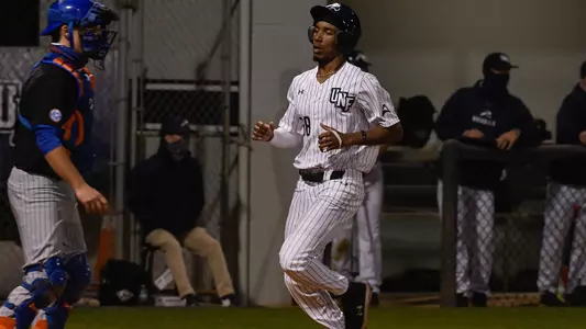 Justin Holmes crosses home plate.