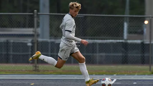 Bryson Smith dribbles the soccer ball against Jacksonville