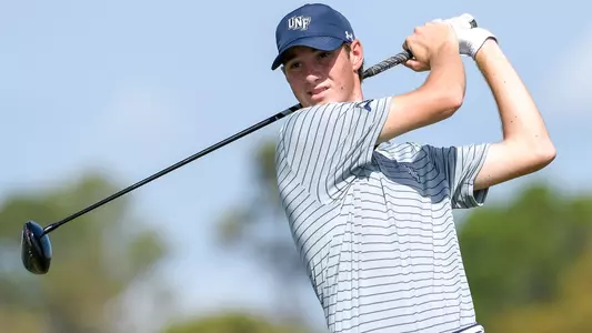 Nick Gabrelcik swings a golf club and watches flight of the ball