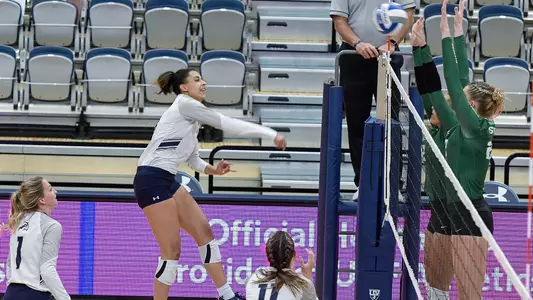 Gabby O'Connell hitting ball hard over the net