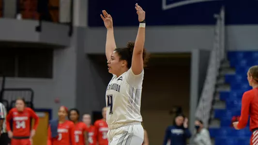 Marissa Mackins throws three-pointer fingers up against Liberty!