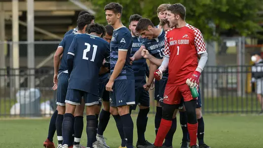 Men's soccer starters huddle before the game at Jacksonville