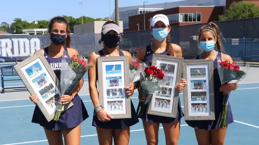Mariotto, Montano, Gorches and Rossi posing on tennis court with flowers and picture frames