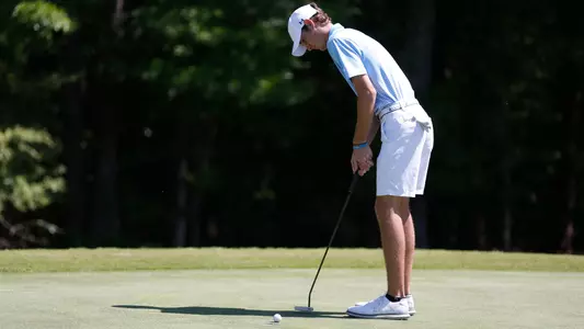 Nick Gabrelcik makes a short putt on the green