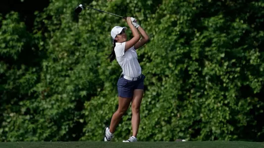 Mindy Herrick follows through on a swing at the tee box