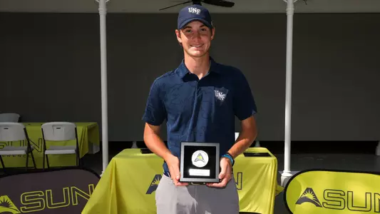 Nick Gabrelcik poses holding his ASUN Runner-Up trophy