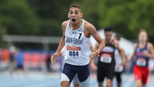Tim Doyle celebrating on track after 800m at Tom Jones Memorial