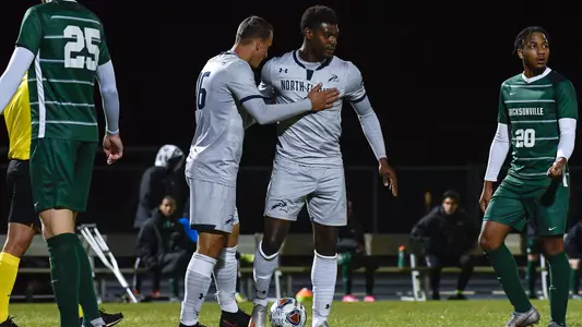 Men's soccer's Mirza Nevoric gives Jovoney Brown a pat after he is fouled on the attack.