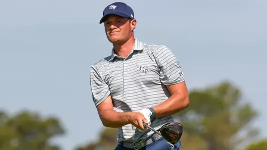 Nick Infanti finishes golf swing and watches flight of his ball