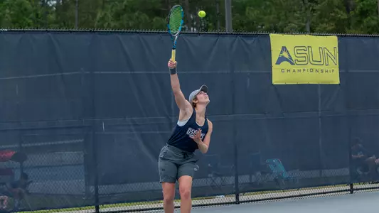Catherine Gulihur serves the ball.