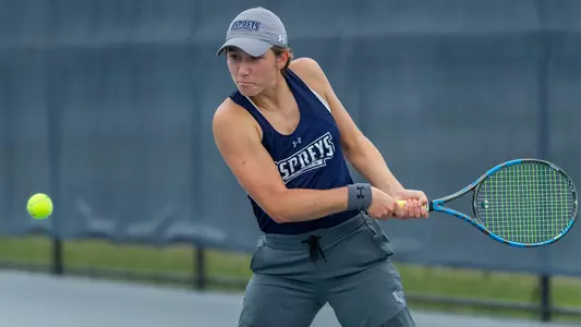 Catherine Gulihur hits a two-hand backhand.
