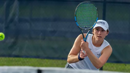 Catherine Gulihur hits a backhand at the net.